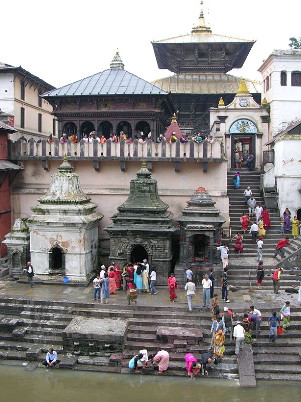 Kathmandu Pashupatinath 01 Pashupatinath Temple From Across Bagmati River The Pashupatinath Temple complex in Kathmandu on the banks of the holy Bagmati River is Nepals most important Hindu temple, and probably the holiest Hindu site outside India. Pashupati is one of the many names of Shiva, the most revered god in the Hindu pantheon, this one meaning the Lord of the Animals. Supposedly Shiva needed a holiday from Mount Kailash and chose the Kathmandu valley. Non-Hindus are not allowed to enter the temple. Below the Pashupatinath temple runs the Bagmati River, a holy river that eventually joins the Ganges. Pilgrims throw the holy water onto themselves, while a few hearty Hindus bathe fully.